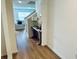 Hallway with wood floors, leading to living room area, and trimmed with white at 239 Se 66Th Ct, Ocala, FL 34472