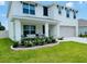 Beautiful two-story home featuring a cozy front porch and lush landscaping at 239 Se 66Th Ct, Ocala, FL 34472