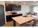 A modern kitchen featuring a large island with counter seating, dark cabinetry, and stainless steel appliances at 239 Se 66Th Ct, Ocala, FL 34472