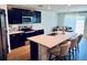 Bright kitchen featuring a large island with seating and modern countertops at 239 Se 66Th Ct, Ocala, FL 34472