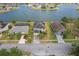 Aerial view showcasing a home near a lake, complemented by lush lawns and mature landscaping at 2803 Boating Blvd, Kissimmee, FL 34746