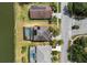 Aerial view of homes with swimming pools and solar panels showcasing the neighborhood layout and waterfront access at 2803 Boating Blvd, Kissimmee, FL 34746