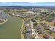 Extensive aerial view of a lake community showcasing numerous homes near the waterfront, with lots of green spaces at 2803 Boating Blvd, Kissimmee, FL 34746