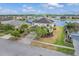 Charming home featuring a lush front yard and lake access, captured in a scenic aerial shot at 2803 Boating Blvd, Kissimmee, FL 34746