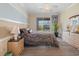 Inviting bedroom with a comfortable bed, ceiling fan, and sliding door access to the lanai with relaxing lake views at 2803 Boating Blvd, Kissimmee, FL 34746