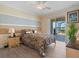 Cozy bedroom with a comfortable bed, ceiling fan, and sliding door access to the lanai with relaxing lake views at 2803 Boating Blvd, Kissimmee, FL 34746