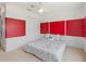 Vibrant bedroom with red accent panels, a ceiling fan, and ample closet space at 2803 Boating Blvd, Kissimmee, FL 34746