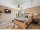 Comfortable bedroom with wood-look floors, a ceiling fan, and a bed with decorative pillows at 2803 Boating Blvd, Kissimmee, FL 34746