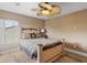 Comfortable bedroom with wood-look floors, a ceiling fan, and a bed with decorative pillows at 2803 Boating Blvd, Kissimmee, FL 34746