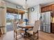 Bright dining area featuring sliding glass doors to the screened-in lanai, a stainless steel fridge, and access to a pool at 2803 Boating Blvd, Kissimmee, FL 34746