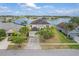 Stunning lakefront home featuring lush landscaping, a spacious driveway, and an attached two-car garage at 2803 Boating Blvd, Kissimmee, FL 34746