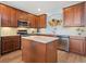 Spacious kitchen with stainless steel appliances, center island, custom cabinets, and tile backsplash, perfect for gourmet cooking at 2803 Boating Blvd, Kissimmee, FL 34746