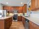 Well-lit kitchen with stainless steel appliances, custom cabinets, stylish backsplash, and generous counter space for cooking at 2803 Boating Blvd, Kissimmee, FL 34746
