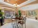 Bright living room featuring large windows, tray ceiling, and a cozy breakfast nook, perfect for relaxing and entertaining at 2803 Boating Blvd, Kissimmee, FL 34746