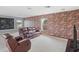 Spacious loft area featuring a brick accent wall and comfortable seating at 2803 Boating Blvd, Kissimmee, FL 34746