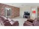 Comfortable loft space with a brick accent wall, entertainment center and relaxing seating at 2803 Boating Blvd, Kissimmee, FL 34746
