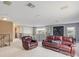 Loft area with cozy seating, plush carpeting, and wrought iron railing overlooking the lower level at 2803 Boating Blvd, Kissimmee, FL 34746
