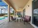 Covered patio with a pool, lake view, outdoor seating, and exercise equipment at 2803 Boating Blvd, Kissimmee, FL 34746