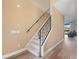 Carpeted staircase with metal railing leading to the upper level of the home, adjacent to a spacious living area at 2803 Boating Blvd, Kissimmee, FL 34746