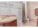 Bright bathroom featuring a shower-tub combo with tile surround, and a large vanity at 2906 Sunset Vista Ct, Kissimmee, FL 34747