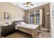 Bedroom with neutral walls, wood-look flooring, and a large window providing natural light at 2906 Sunset Vista Ct, Kissimmee, FL 34747