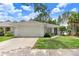 Charming single-story home featuring a two-car garage and well-maintained landscaping under a bright, sunny sky at 2906 Sunset Vista Ct, Kissimmee, FL 34747