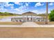 Scenic gazebo overlooking a tranquil lake, an ideal spot for relaxation and enjoying nature at 2906 Sunset Vista Ct, Kissimmee, FL 34747