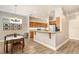 Open-concept kitchen with wood cabinets, stainless steel appliances, and a breakfast bar at 2906 Sunset Vista Ct, Kissimmee, FL 34747