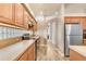 Kitchen with stainless steel refrigerator, wood cabinets, and light countertops at 2906 Sunset Vista Ct, Kissimmee, FL 34747