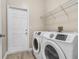 Convenient laundry area featuring modern, front-load washer and dryer and overhead shelving at 2906 Sunset Vista Ct, Kissimmee, FL 34747