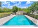 Community pool featuring a clear blue pool, a covered seating area and meticulous landscaping at 2906 Sunset Vista Ct, Kissimmee, FL 34747