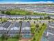 Expansive aerial view showcasing a community with modern homes, lush greenery, and private screened-in pools at 303 Ocean Course Ave, Davenport, FL 33896