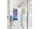 Bright bathroom featuring a glass shower, light fixtures, and a glimpse into the bedroom at 303 Ocean Course Ave, Davenport, FL 33896