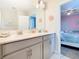 Bright bathroom with dual vanity, granite countertops, and decorative accents at 303 Ocean Course Ave, Davenport, FL 33896
