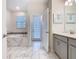 Bright bathroom boasts a soaking tub, double vanity, and stylish tile, perfect for relaxation and comfort at 303 Ocean Course Ave, Davenport, FL 33896