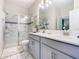 Bathroom featuring double vanity, glass enclosed shower, and tile flooring at 303 Ocean Course Ave, Davenport, FL 33896