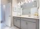 Bathroom featuring a double vanity with gray cabinets and tile flooring at 303 Ocean Course Ave, Davenport, FL 33896