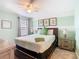 Bedroom features a comfortable bed, ceiling fan, nightstands, and window, perfect for a cozy and peaceful night's sleep at 303 Ocean Course Ave, Davenport, FL 33896