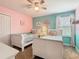 Charming ' room with twin beds, pastel walls, and bright, natural light at 303 Ocean Course Ave, Davenport, FL 33896
