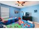 Playful ' bedroom with twin beds, ceiling fan, and superhero-themed decor at 303 Ocean Course Ave, Davenport, FL 33896