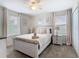 Comfortable bedroom with ceiling fan, carpet, and plenty of natural light at 303 Ocean Course Ave, Davenport, FL 33896