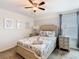 Bedroom showcasing cozy bed, ceiling fan, neutral tones, and window at 303 Ocean Course Ave, Davenport, FL 33896