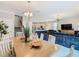 Open-concept dining area with modern chandelier, and view to living room at 303 Ocean Course Ave, Davenport, FL 33896