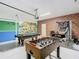 Finished garage space used for recreation with a pool table, foosball table and basketball game at 303 Ocean Course Ave, Davenport, FL 33896