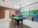 Entertainment garage with a pool table, foosball table, and wall mounted basketball game at 303 Ocean Course Ave, Davenport, FL 33896