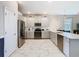 Modern kitchen featuring gray cabinets, stainless appliances, and white countertops at 303 Ocean Course Ave, Davenport, FL 33896