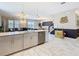 Open-concept kitchen with island seating and stainless steel appliances at 303 Ocean Course Ave, Davenport, FL 33896