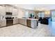 Bright, open kitchen with stainless steel appliances, tiled floor, and island at 303 Ocean Course Ave, Davenport, FL 33896