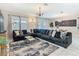 Bright living room with large sectional, chandelier, and view to dining area at 303 Ocean Course Ave, Davenport, FL 33896