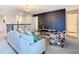 Cozy living area showcasing a patterned accent chair, neutral sofa, and dark accent wall at 303 Ocean Course Ave, Davenport, FL 33896